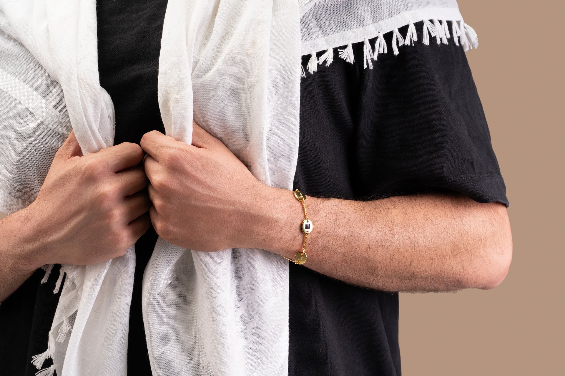 A jewelry piece displayed on a light surface, featuring a delicate chain with multiple connected decorative elements.