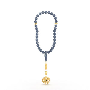 Gold tasbih with blue beads and a decorative gold pendant featuring a Quran-inscribed nano chip, displayed on a white background.