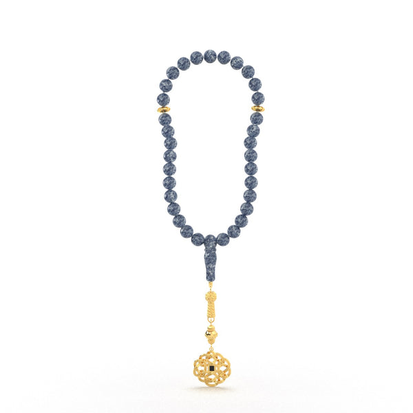 Gold tasbih with blue beads and a decorative gold pendant featuring a Quran-inscribed nano chip, displayed on a white background.
