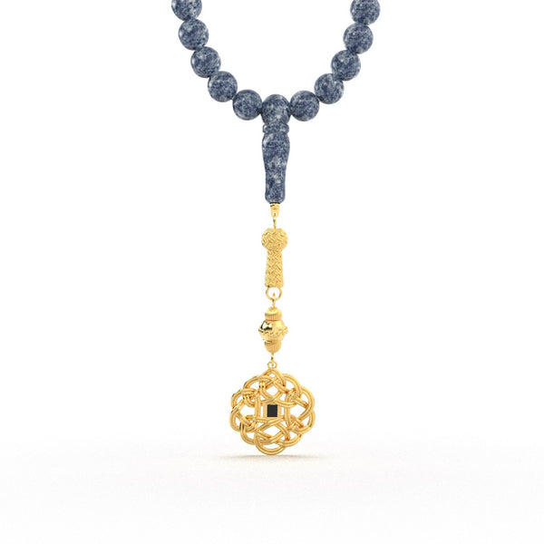 Gold tasbih with blue beads and a decorative gold pendant featuring a Quran-inscribed nano chip, displayed on a white background.