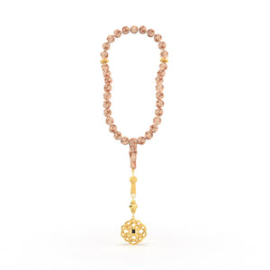 Elegant tasbih featuring pink and white gemstone beads with a beautifully crafted gold pendant, containing a nano chip micro-engraved with the entire Quran.