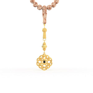 Luxurious pink-and-white gemstone tasbih paired with an ornate gold pendant, designed with a nano chip that carries a micro-engraved complete Quran.
