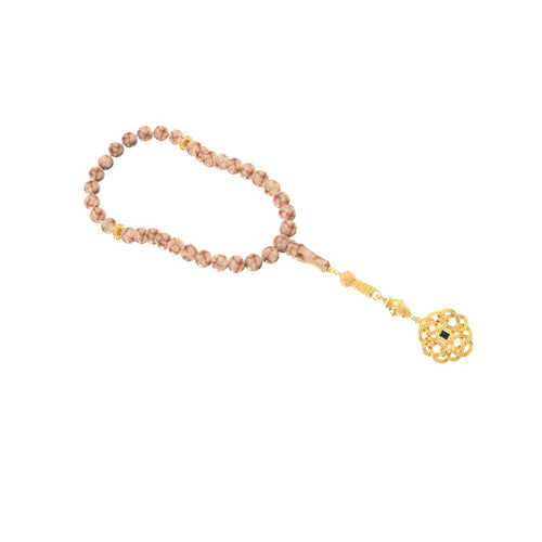 Prayer beads (misbaha) with pink-and-white stones and a gold decorative pendant, featuring a nano chip micro-engraved with the entire Quran.