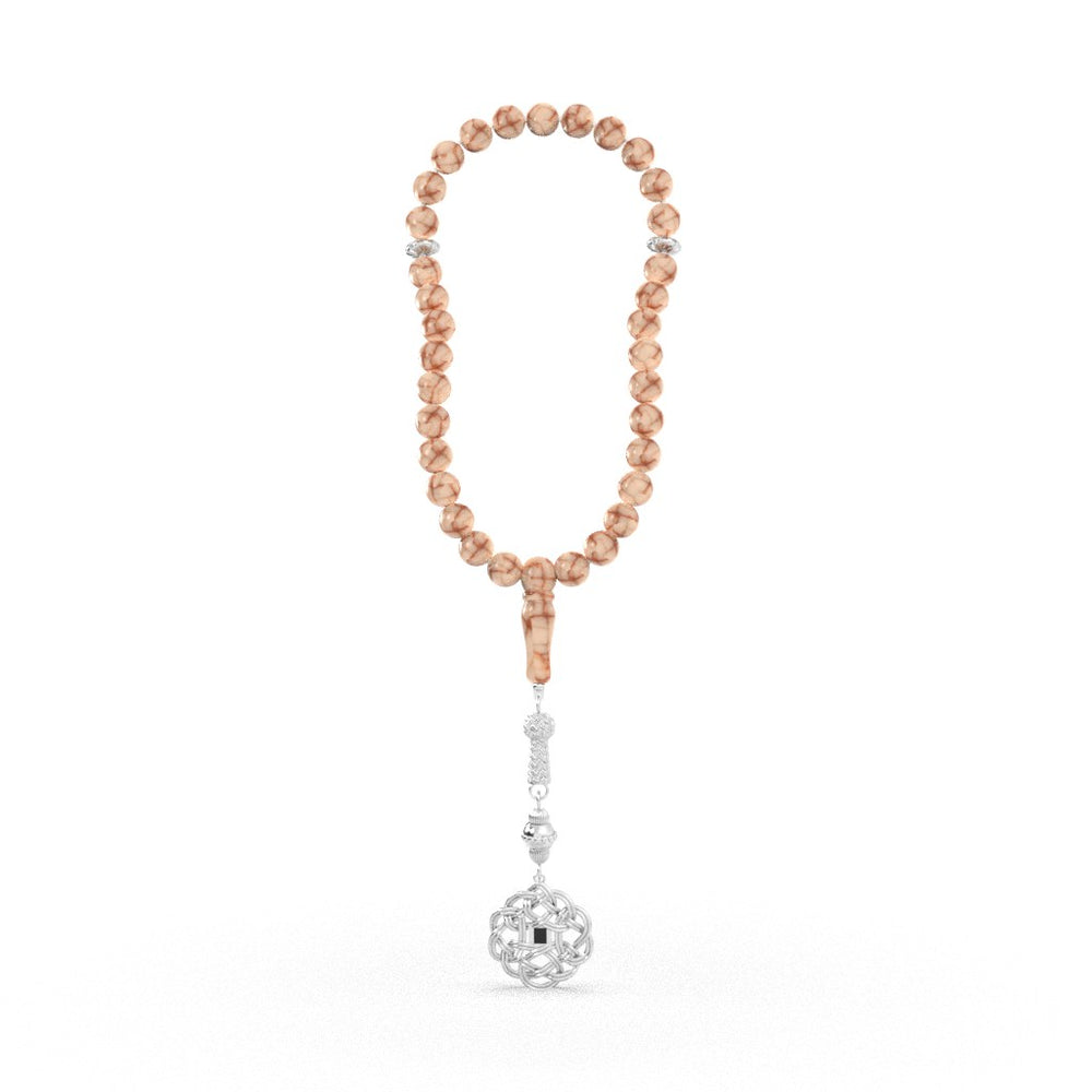 Refined tasbih with pink and white stones and a decorative white-gold pendant, containing a nano chip engraved with the entire Quran in micro detail.
