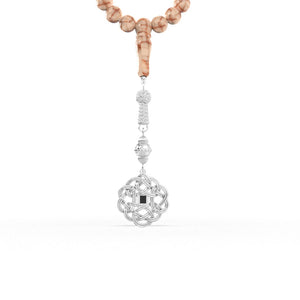 White gemstone tasbih with uniform beads and a detailed white-gold pendant, featuring an embedded nano chip micro-engraved with the full Quran text.