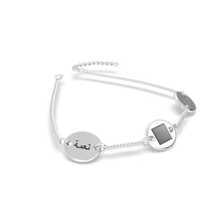 Silver bracelet with three round-and-square pendants, featuring a central square black nano chip inscribed with the entire Quran, displayed on a white background.