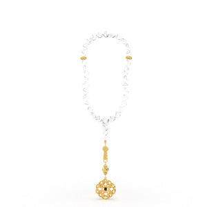 Gold tasbih with white stones and a decorative gold pendant featuring a nano chip micro-engraved with the entire Quran.