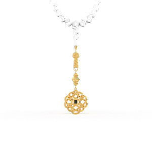 Gold tasbih with white stones and a decorative gold pendant featuring a nano chip micro-engraved with the entire Quran.