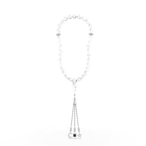 Silver tasbih with white stones and a silver pendant containing a Quran-inscribed nano chip, displayed on a white background.