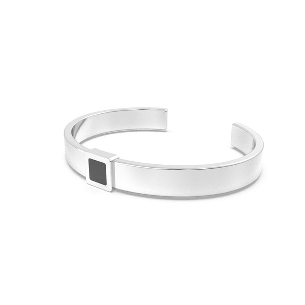 Silver cuff bracelet featuring a built-in black nano chip containing the full Quran, displayed on a white background.