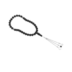 Silver tasbih with black beads and a silver tassel featuring three pendants, with the central square pendant containing a black nano chip inscribed with the entire Quran, displayed on a white background.
