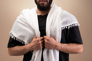 Silver bracelet with three round-and-square pendants, featuring a central square black nano chip inscribed with the entire Quran, displayed on a white background.