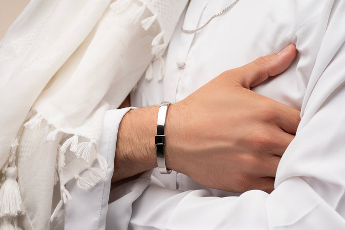 Gold cuff bracelet featuring a built-in black nano chip containing the full Quran, displayed on a white background.