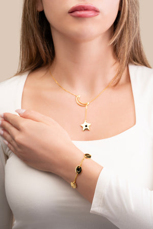 Gold necklace featuring a crescent and star pendant, with the star containing a black nano chip inscribed with the entire Quran, displayed on a white background.